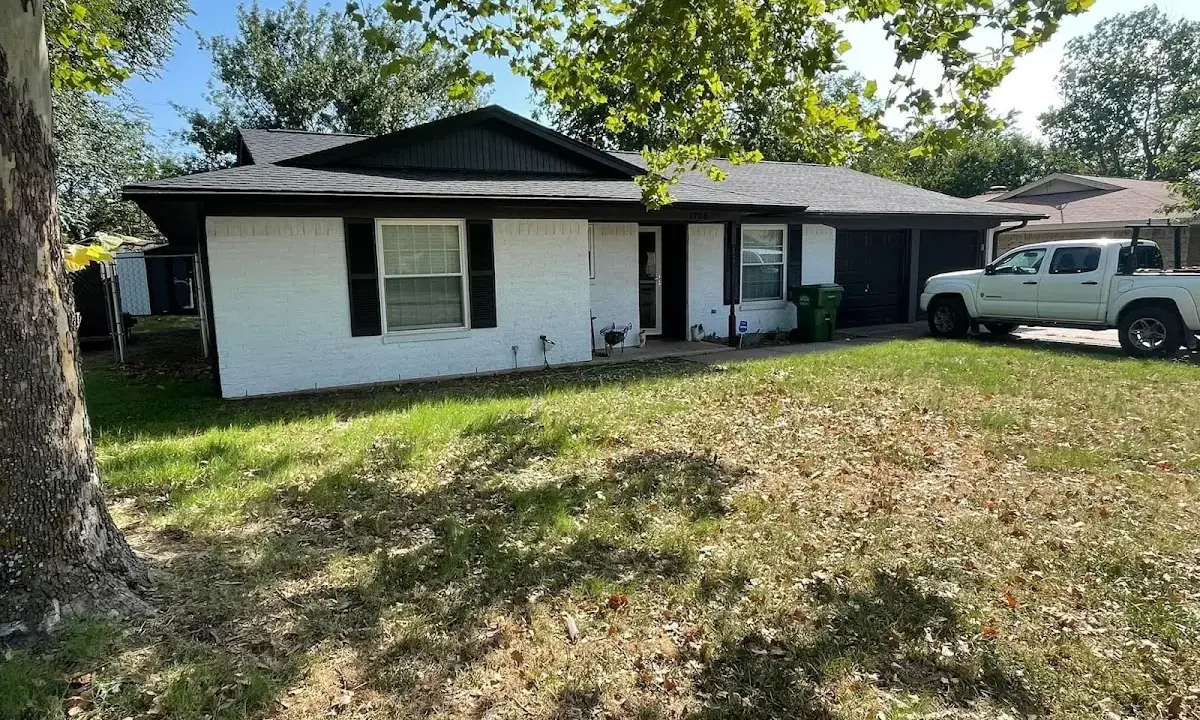 Professional roofing crew working on a residential roof in Country Homes